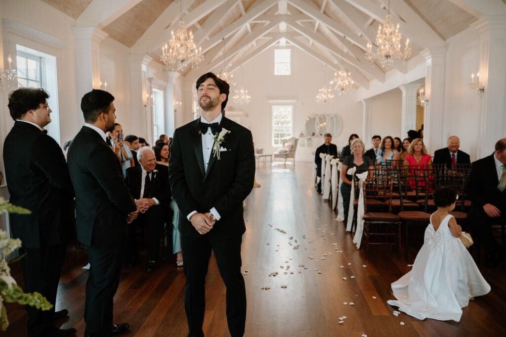 Groom awaiting his bride to come down the aisle before ceremony